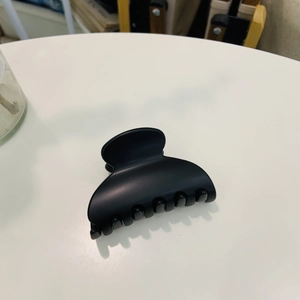 Detail of matte black heart hair claw clip showing a durable grip and elegant texture