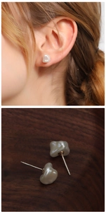 Detail showing natural baroque freshwater pearl earrings with silver studs on model