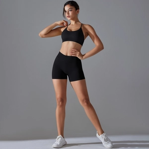 Detailed side view of black seamless cross-back sports bra and high-waist biker shorts set