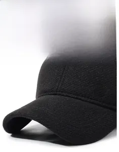 Detailed view of black textured winter baseball cap with side metal fashion emblem