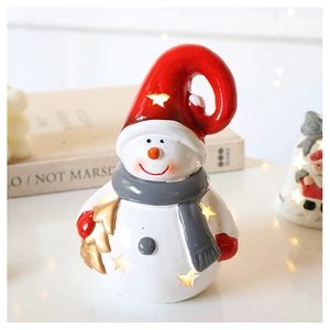 Close-up of a glowing snowman Christmas ornament with cutout stars and a gold tree
