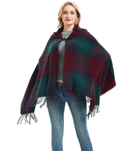 Detail of burgundy and dark green plaid hooded poncho with toggle closure and fringe