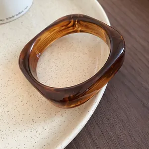 Minimalist wide acrylic amber leopard print bangle with tortoiseshell pattern finish