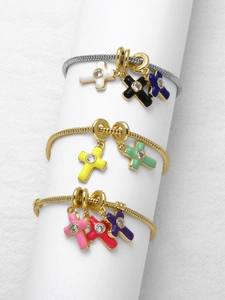 Detail view of colorful enamel cross pendants with zircon on gold and silver snake chains