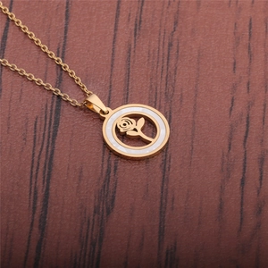 Macro shot of gold titanium necklace featuring a hollow rose pendant with shell inlay