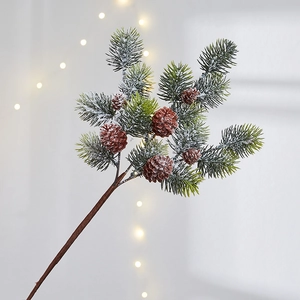 Artificial Christmas pine branch with pine cones and white snow frost for holiday decor