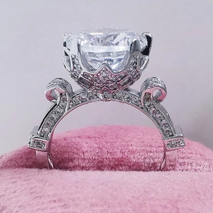 Macro detail of luxury crown setting ring with engraved vintage scrollwork on the band