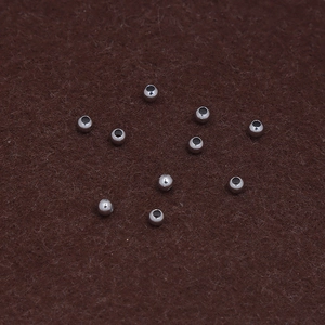 Polished S925 sterling silver beads for DIY jewelry making spread on a dark textured background