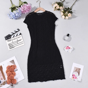 Detailed flat lay of black lace short sleeve dress with decorative lifestyle accessories