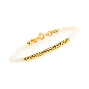 Detailed macro view of beaded bracelet featuring gold-plated accents and lobster clasp