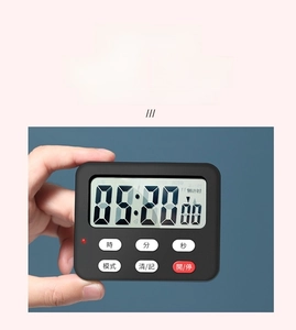 Handheld view of a compact black digital kitchen timer with a large LCD screen and buttons