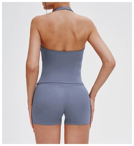 Rear view of a backless halter yoga top and high-waisted shorts in grey-blue stretch fabric