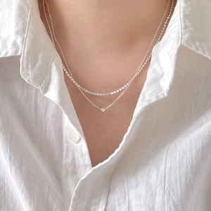 Minimalist double layer 925 sterling silver chain necklace worn by a model