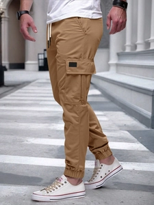 Detail showing side cargo pockets and drawstring waist on khaki joggers