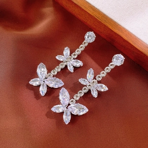 Close-up of elegant zircon butterfly tassel drop earrings with sparkling silver finish