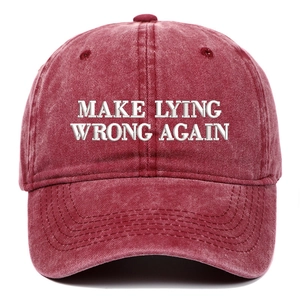 Detail of white embroidery Make Lying Wrong Again on washed red cotton baseball cap