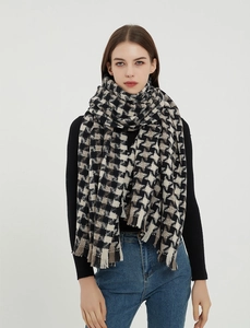 Detail shot of black and white houndstooth scarf showing thick texture and fringe edges