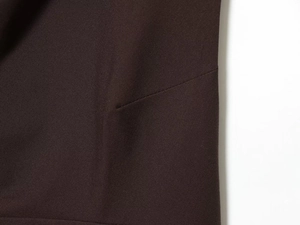 Close-up of dark brown twill fabric texture and fine stitching detail on a women top