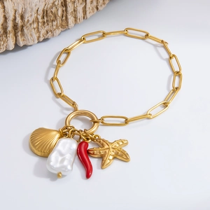 Golden paperclip chain bracelet featuring shell, starfish, red pepper and pearl charms