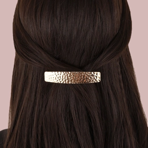 Elegant gold metal hair clip with textured hammer pattern finish for half-up hairstyles