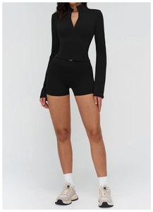 Detail of black sports set featuring a stand-up collar zipper top and high-waist yoga shorts