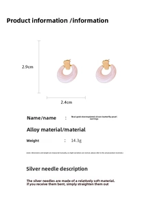 Detail view of pink and gold circle earrings showing dimensions 2.9x2.4cm and silver needles