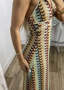 Detailed view of colorful wavy crochet knit pattern and backless design on the dress