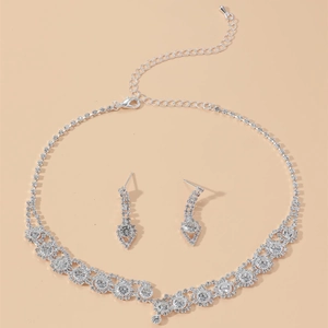 Luxury bridal jewelry set featuring silver flower necklace and drop earrings with zircons