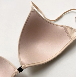 Macro detail of the nude seamless bra showing the smooth fabric texture and cup stitching