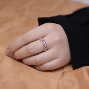 Macro shot of a gold-plated sterling silver ring with rectangular pink zircon gemstones