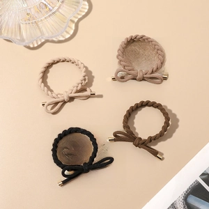 Detail of four-piece braided elastic hair ties with bow accents and gold metal tips