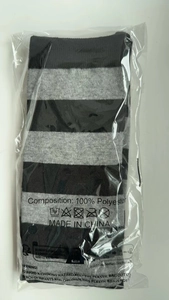 Detailed view of black and gray striped socks in retail transparent packaging
