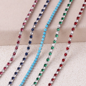 Detail of colorful 3.0 zircon tennis chains in turquoise and red on silver base