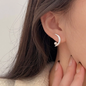 925 sterling silver crescent moon earrings with white pearl on model's ear