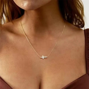 Detail of elegant gold horizontal cross pendant on a minimalist S925 silver necklace
