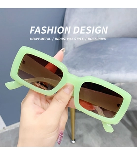 Close-up of light green rectangular sunglasses in trendy vintage candy-colored resin