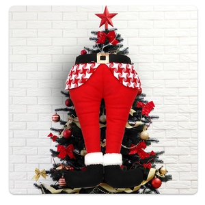 Detailed plush Christmas elf legs tree topper with red fabric and polka dot skirt