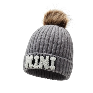 Gray chunky knit beanie with brown faux fur pom and white MINI embroidery