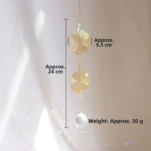 Detailed view of golden clover suncatcher with faceted crystal ball and rainbow prism effect