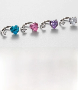 Macro shot of titanium steel horseshoe rings with colorful 5A sparkling zircons