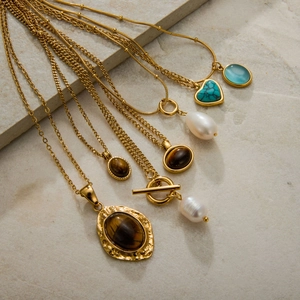 Golden titanium steel necklace set with tiger eye, pearl and turquoise charms