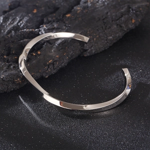 Minimalist silver Mobius loop stainless steel open cuff bracelet on black stone