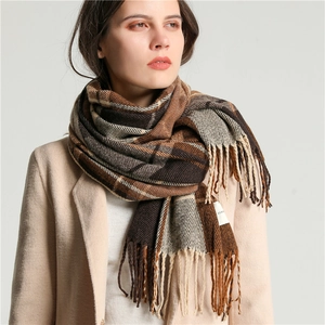 Classic plaid tassel scarf in brown and beige tones styled on a model for winter warmth