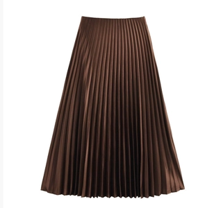 Close-up of deep brown pleated midi skirt featuring fine satin accordion folds and elegant drape