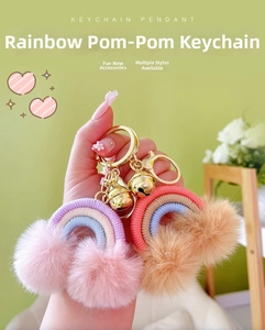Detail of bohemian rainbow pom pom keychains with golden bells and lobster clasps