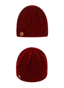 Close-up of chunky knit pattern and premium leather tag on dark red winter beanie