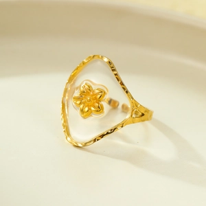 Detail of golden ring with resin heart petal and hammered adjustable band texture