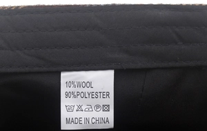 Close-up of internal fabric label showing 10% wool and 90% polyester material composition