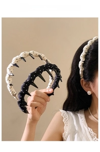 Close-up of white polka dot fabric headband featuring non-slip internal plastic teeth