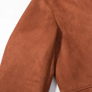 Detailed macro view of the shoulder stitching on a brown suede vintage work jacket